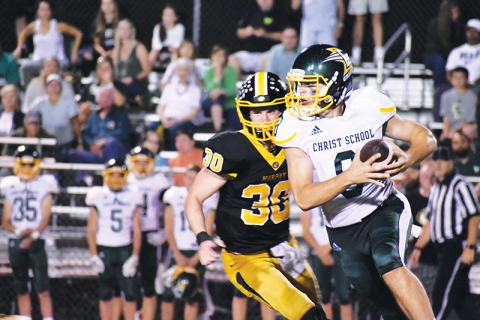 Murphy’s Chandler Wood chases Christ School quarterback Navy Shuler on Friday.