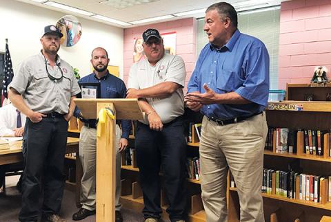 Murphy Electric Power Board employees (from left) John Hall, Chris Raper and Justin Coker, along with President Larry Kernea, accept a certificate of appreciation Thursday for their efforts in working on the playground at Murphy Elementary School.