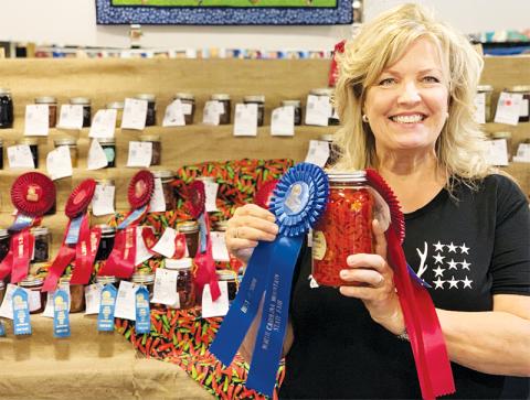 Rachael Linton Ritchie holds her award-winning sliced hot peppers in vinegar at the N.C. Mountain Fair. Photo courtesy of Rachel Linton Ritchie
