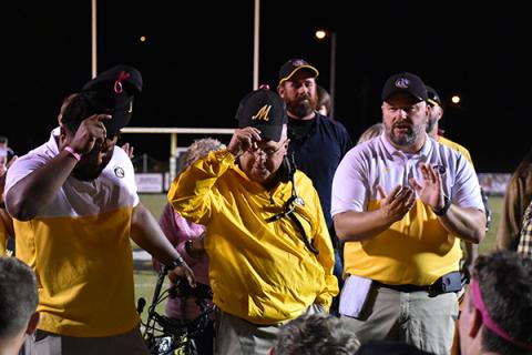 Murphy Coach David Gentry tips his hat to the crowd of supporters and players gathered around.