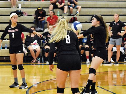 Andrews’ Brooke Phillips returns a serve between teammates Sydney Postell (3) and Emma Jones (8) against Hiwassee Dam earlier this season.