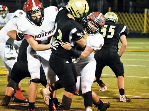 Andrews’ Jimmy Miller wraps up Hayesville’s Blake McClure during Friday night’s game.