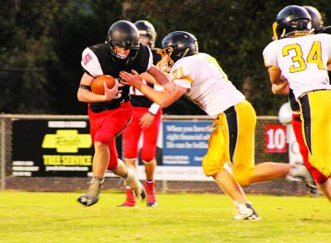 Andrews’ Isaac Weaver looks to shed a Murphy tackler during Thursday’s game.  Photos by Mary White