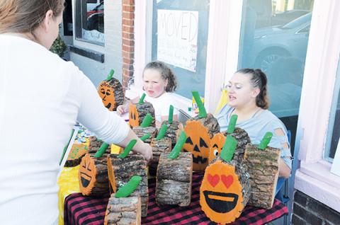 7-year-old Jemmabelle Hill and her mother, Kristina Hill (right), sell Stumpkins at Art Walk. Photo by Penny Ray