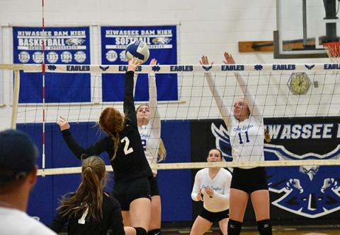 Andrews' Kinsleigh Dartez (2) looks to kill the ball with Hiwassee Dam's Ashlyn Weaver and Kayley Sells looking to block.