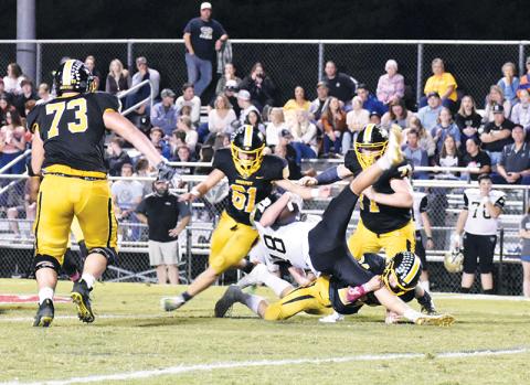 Murphy defenders swarm as linebacker Ray Rathburn upends a Hayesville runner during the Bulldogs’ 62-14 shellacking of the Yellow Jackets on Friday night.