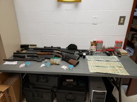 Police seized guns, drugs, cash during an early morning raid in Andrews last week.