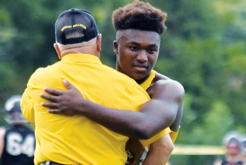 Devonte Murray and Coach David Gentry share an embrace before Murphy’s season-opening win against Pisgah.