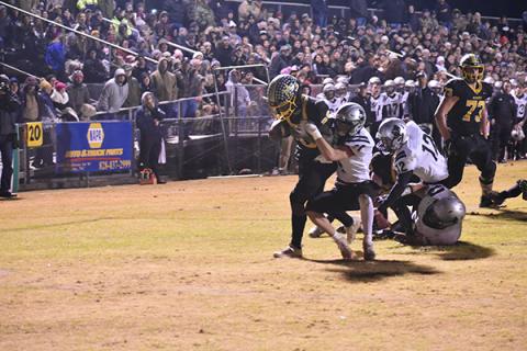 Murphy's Devonte Murray drags a Robbinsville defender into the end zone Friday night in the Bulldogs' loss to the Black Knights. 