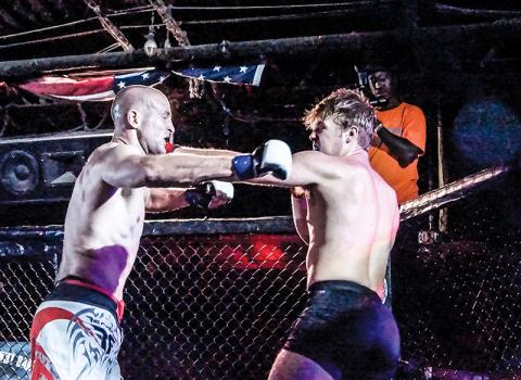 Former Murphy Bulldog Cory Farmer (right) lands a left jab against Gabriel Atkinson in his amatuer Mixed Martial Arts debut with Valor Fighting Challenge on Sept. 6. Photos by Janet Wohler/Valor Fighting Challenge