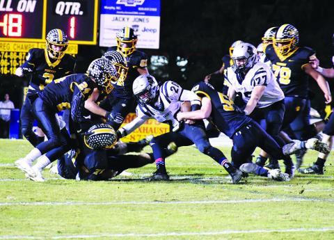 Murphy’s Landon Jordan wraps up Robbinsville running back Lex Hooper in the Bulldogs’ loss to the Black Knights. Photo by Noah Shatzer
