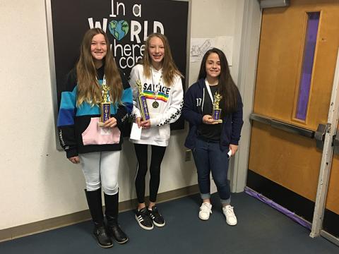 A happy Hailie Madlock (center) took home the first-place trophy Thursday morning during the 14th annual Cherokee County Middle Schools Spelling Bee at Martins Creek School. Fellow Martins Creek student Alexis Tighe (left) finished second, while Isabelle Gladson of Ranger (right) took third.