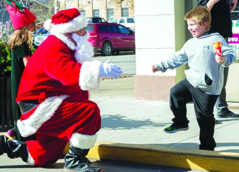 A child enjoys time with Santa during last year’s event.