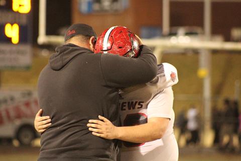 Mary White/Contributing Photographer: Senior Brawley Stillwell and Andrews head coach James Phillips share a moment following the Wildcats’ second-round loss to the second-seeded Elkin Elks.