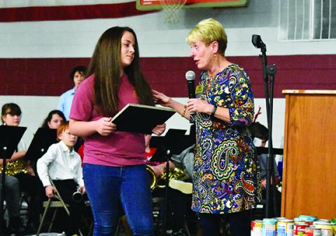 Isabelle Gladson (left) listens as Laura Misner of the College Foundation of North Carolina presents her with the Victor E. Bell Jr. Scholarship. Photo by Samantha Sinclair