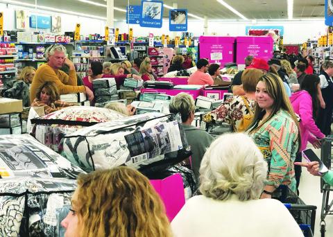 Walmart patrons in Murphy gather around displays of bed and bathroom items before Black Friday sales begin Thursday evening. Photo by Penny Ray