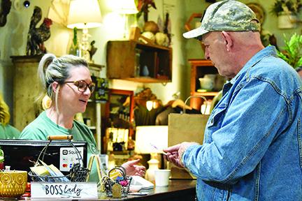 Black & White Market owner Keisha Dockery accepts payment from David Mackie on Small Business Saturday. Photo by Samantha Sinclair
