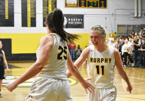 Murphy’s Torin Rogers (11) emphatically celebrates an and-one layup by Sarah Pullium (25) in the Lady Bulldogs’ dominant win against Hayesville. Photo by Noah Shatzer