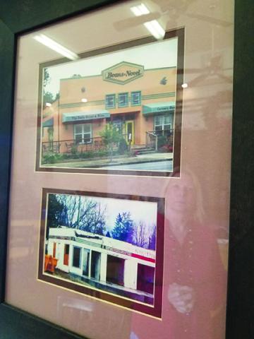 On the wall at FernCrest Winery in Andrews, Jan Olson (reflected) has framed photos that show the building’s past. Photo by Samantha Sinclair