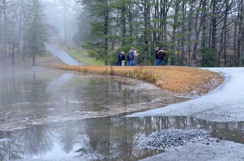 Cherokee County and state officials examine the structural integrity of Tanglewood Dam in Murphy last week. Photo by Penny Ray