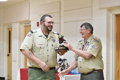 Murphy Cubmaster Josh Frentz accepts the Big Bear trophy from District Chairman Eddie Hollifield. Photo by Samantha Sinclair