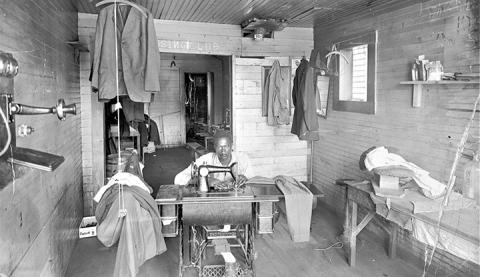 William Bowens sits in his business, The Pressing Club, in 1916. It was the only black-owned business in Andrews. Bowens gave Happytop its name.