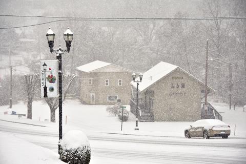 Snow practically created a whiteout Saturday morning at the L&N Depot in downtown Murphy. Photo by Samantha Sinclair