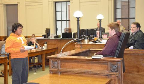 Antonio Hernandez (defense attorney) questions William Wood as Darrel Curtis (witness for the defense) during a mock trial based on the book The Outsiders. Photo by Penny Ray