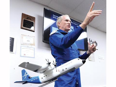 Capt. Wayne Roberts speaks with students and faculty in the aviation class at Tri-County County Early College High School on Feb. 11. In the foreground is a model of the Lockheed-Martin C-130 Hercules cargo plane that Roberts helped develop. He also flew it into the history books at a Great Britain airshow in 2018, when he became the only pilot to take that plane through a complete loop. Photo by Scott Wallace