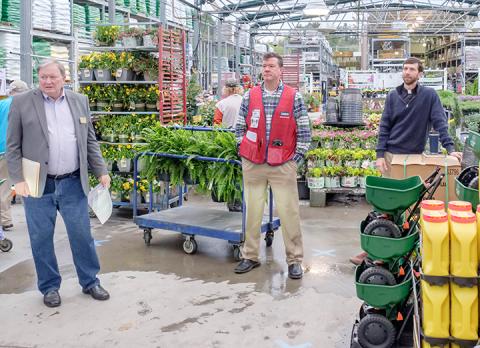 Murphy Mayor Rick Ramsey and Lowe’s Manager Jeff Stallings (from left) share with the public during a press conference Monday morning in the garden center everything the store has done to help prevent the spread of COVID-19 after an employee tested positive last week. The Rev. Will Posey from Murphy First United Methodist Church (right) led a prayer for God to keep people safe from the coronavirus. Photo by Sam Jokich
