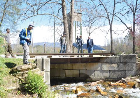 Brody Holloway, Matt Jones and Commissioner Cal Stiles (from left) discuss the progress of construction at Snowbird Wilderness Outfitters. Photo by Penny Ray