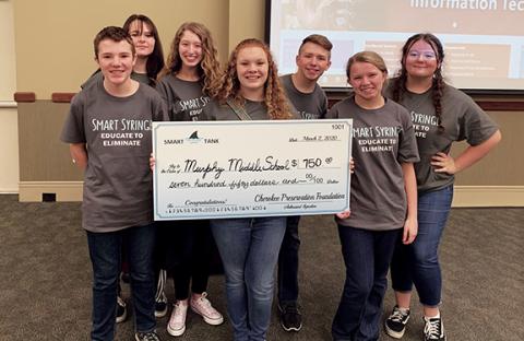 Lyden Raxter, Lexie Graves, Trista Allison, Bria Haines, Jonah Hardin, CeCe Ward and Trinity Mickens (from left) pose with the big check from the Smart Syringe.