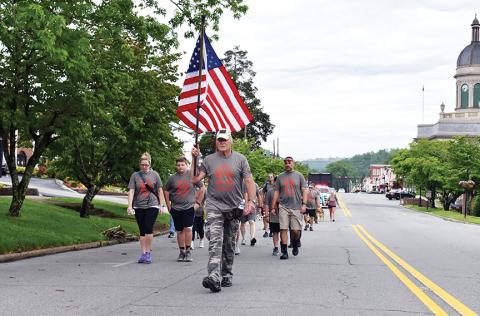 U.S. Air Force veteran Mark Narcowitz leads the procession of 22 Hump walkers down Peachtree Street in Murphy on the morning of May 23. Photo by Noah Shatzer