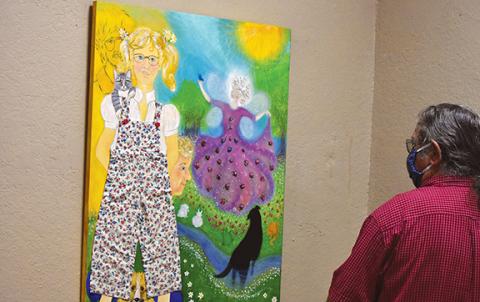 Betsy Henn Bailey’s whimsical paintings show how she sees the world and herself. One of her paintings in the “Betsy & Friends” exhibit shows herself with one of her friends, Lois Yeager, who often uses cats and critters in her works, Cherokee County Arts Council Director David Vowell explained. Photo by Samantha Sinclair