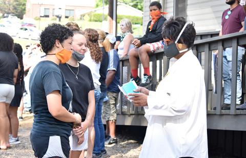 Ann Miller Woodford of Andrews (right) counsels Te’Lor Allen of Murphy before Thursday’s march downtown. Photo by Samantha Sinclair