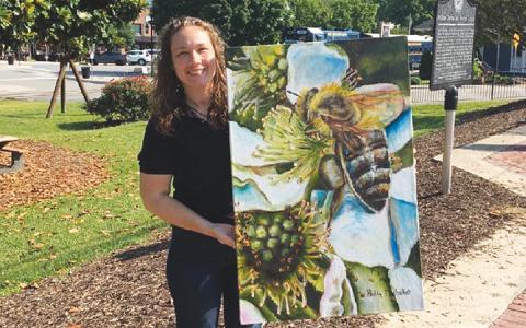 Holly Michelle Hargus shows off a painting that will be on display during the Cherokee County Arts Council’s July exhibit.
