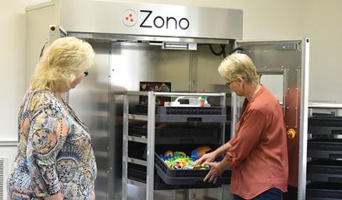 Health specialist Joyce Young and Head Start center director Sharon Palmer show how the Zono Cabinet works at Hilltop Head Start in Andrews. Photo by Samantha Sinclair