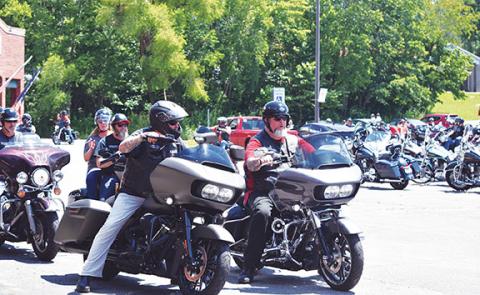 Bikers led by Bubba Morin (in red) get into position to start the motorcycle run Saturday morning at Ronnie’s Restaurant in Andrews. Photo by Samantha Sinclair