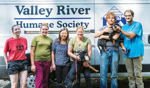 Sam Jokich/For the Cherokee Scout Workers at the Valley River Humane Society’s animal shelter off U.S. 19/74 in Marble include (from left) Hannah Christopher, Hailey Henson, Carol Reagan, Caleb Atherly, Kirsty Waller (one of the managers) and Scotty Derreberry. The larger dog is Abe, the puppy is Drew.