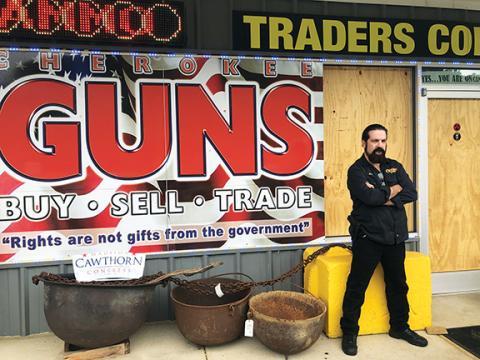 Penny Ray/pennyray@cherokeescout.com “Doc” Wacholz stands outside Cherokee Guns on U.S. 64 West, which was burglarized on Sept. 13. The store’s window and door were boarded up until the glass could be replaced.
