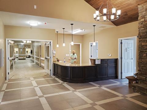 Samantha Sinclair/scoutingaround@cherokeescout.com Dawn Ciokan, events coordinator for Century Care Management, prepares the reception desk in the lobby at the new Murphy Rehabilitation & Nursing facility.