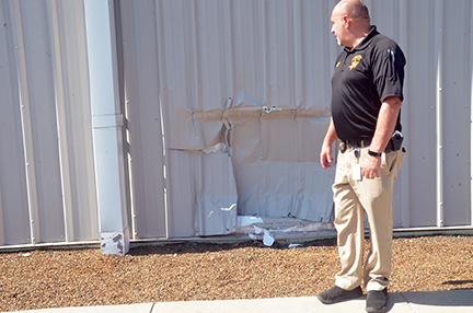 Sheriff Derrick Palmer explains how a driver crashed into the side of his office building on Regal Street. Photo by Penny Ray