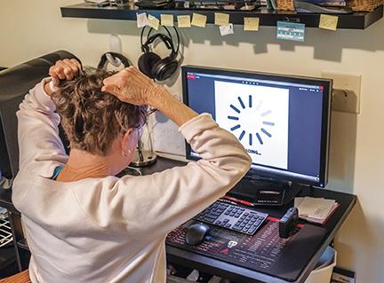 Waiting for your work to download without broadband internet service can make users want to pull their hair out in rural Cherokee County. Photo illustration by Sam Jokich