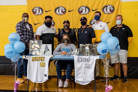 Murphy senior Annie Kate Dalton signed her letter of intent to play collegiate softball at the University of North Carolina in Chapel Hill on Thursday. Dalton, who will be kicking for the football team this season, was joined by coaches (from left) Mark Pickens, Thomas Nelson, David Gentry, Joseph Watson, Will Posey and Erik Laney.