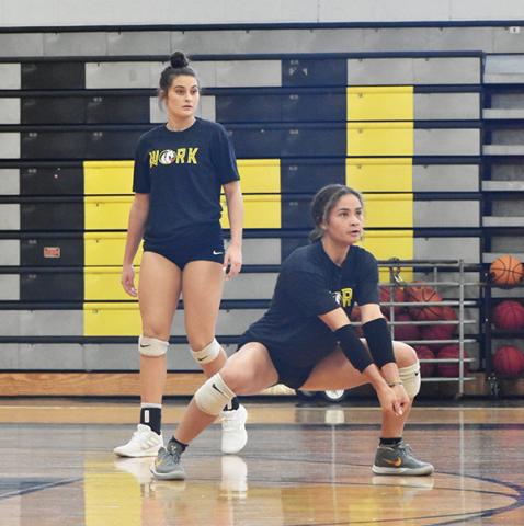 Murphy High School seniors Sarah Pullium (back) and Grace Nelson (front) participate in returning drills during the Lady Bulldogs’ second practice of the season Friday. 
