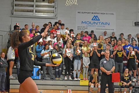 Lady Bulldogs outside hitter Grace Nelson lines up a serve in front of Murphy’s student section. Limits on attendance for this year’s volleyball season are expected, but guidelines for spectators have yet to be announced by the state.