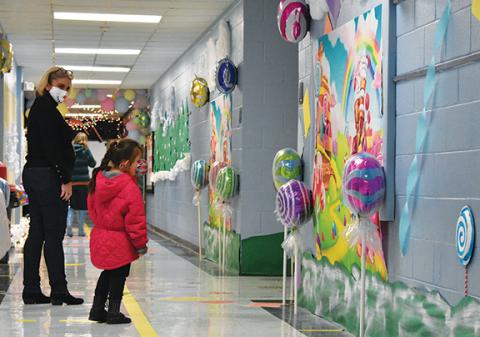 First-grader Hailey Lopez, a remote student at Andrews Elementary School, got to tour the school with her teacher, Sandy Faggard, on Dec. 16 and see her school decorated as Candy Land. Photo by Samantha Sinclair