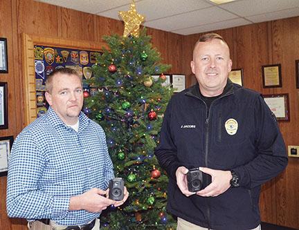 Penny Ray/pennyray@cherokeescout.com Murphy assistant police chief Dustin Smith and Police Chief Justin Jacobs demonstrate the department’s new body cameras.