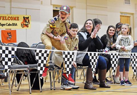 Ethan Reeves jumps for joy as his car comes in first place during the Nantahala District of Cub Scouts’ Pinewood Derby on March 1.