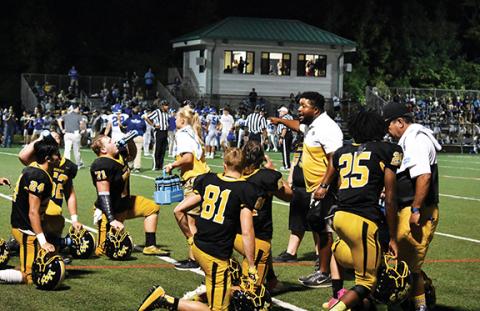 Murphy High School assistant football coach Thomas Nelson fires up his players on the sidelines during a game in the 2019 season. However, his life shows Nelson’s not really the “bad guy.”